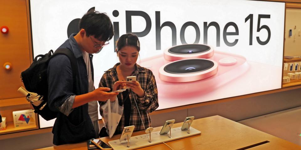 Customers trying out Apple's iPhone 15 at an Apple store in Shanghai, China.