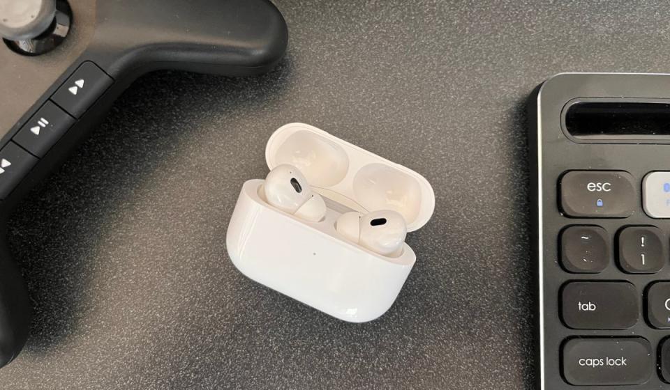 The new AirPods Pro shown inside their charging case.