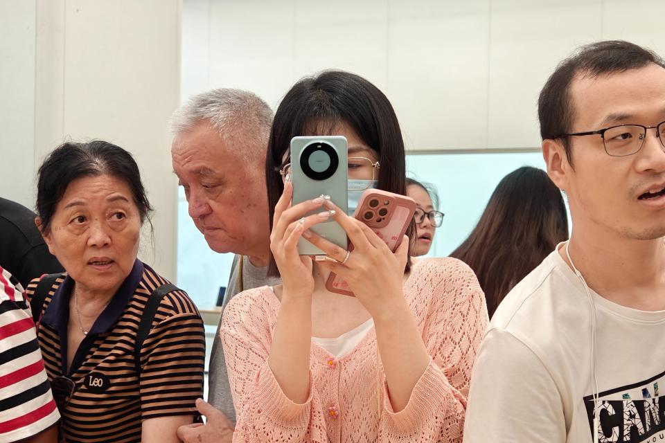 A customer tries out Huawei Mate 60 smartphone at a Huawei flagship store on September 4, 2023 in Shanghai, China.