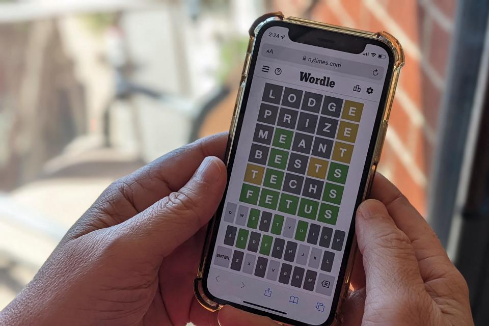 This photo illustration shows a person playing online word game "Wordle" on a mobile phone in Arlington, Virginia, on May 9, 2022.