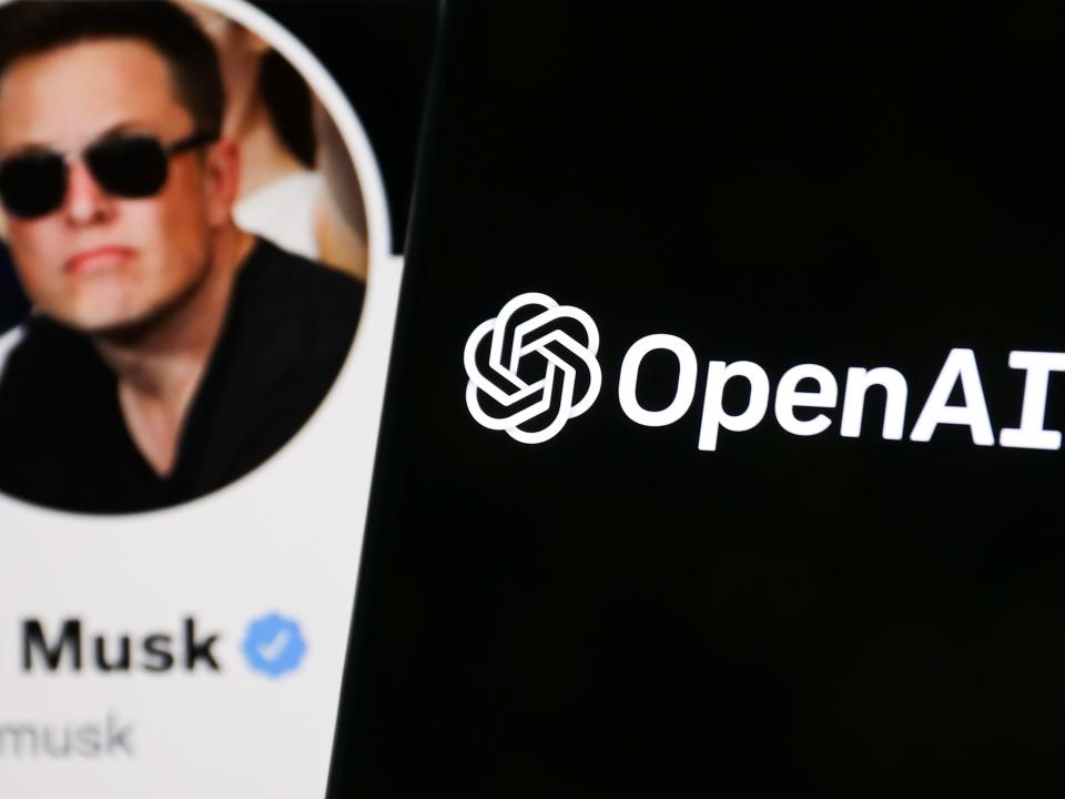 OpenAI logo displayed on a phone screen and Elon Musk's Twitter account displayed on a screen in the background