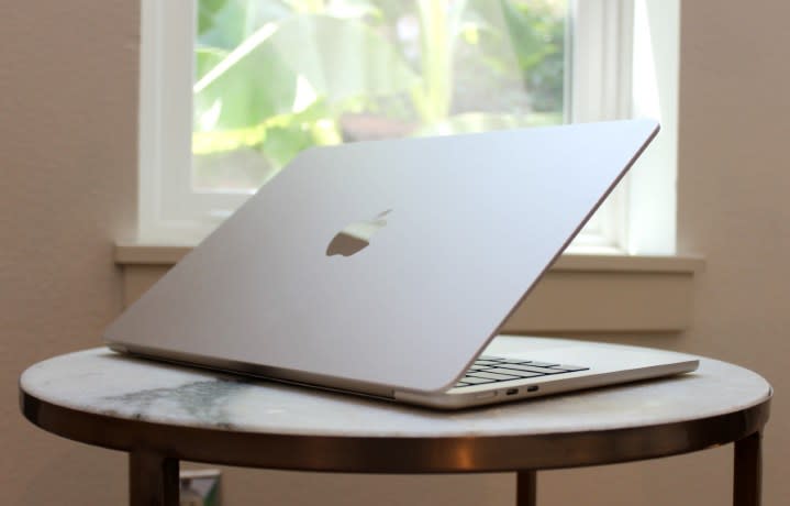 The MacBook Air on a table in front of a window.