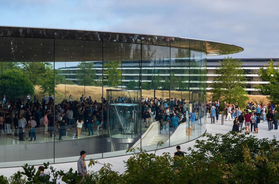 Steve Jobs Theater, a circular building with floor to ceiling glass windows