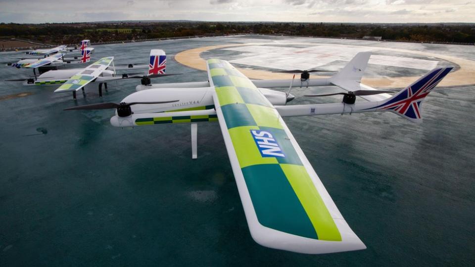 A large drone with the NHS logo and UK flag on it