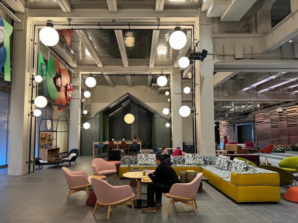Several people sit in the Great Hall Work Lounge at Google's new New York headquarters