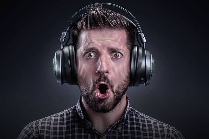 THX Spatial Audio image of a man looking surprised while wearing headphones.