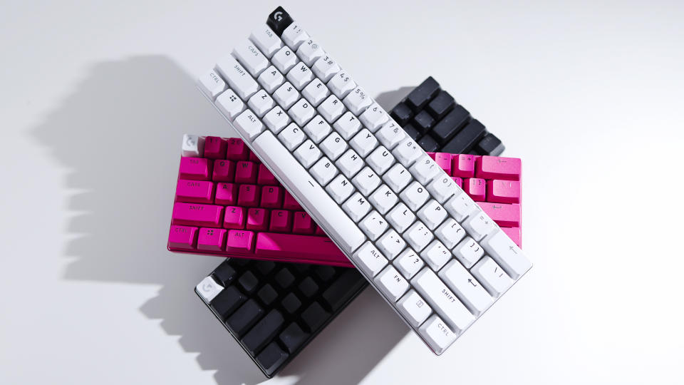 Three Logitech G Pro X 60 keyboards -- one white, one pink, and one black -- sit stacked on top of one another against a white background.