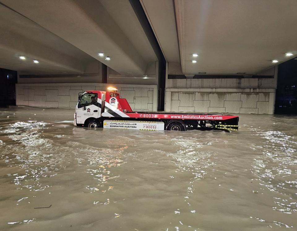A submerged duty machine is seen after heavy rain in United Arab Emirates on April 16, 2024.