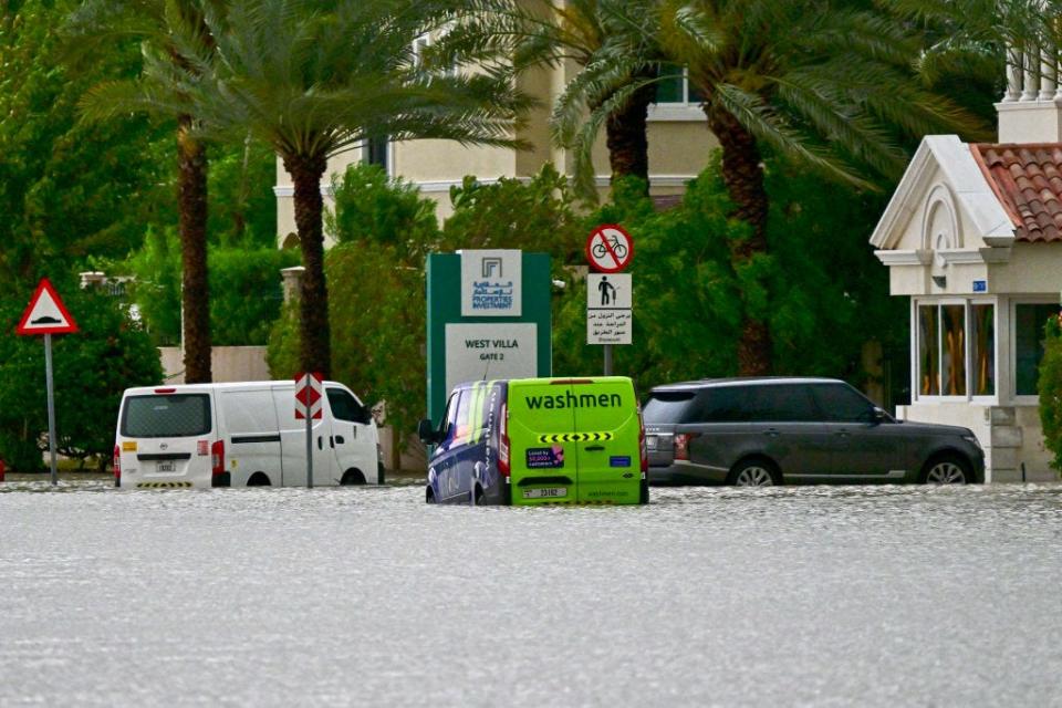 Vehicles are stranded on a flooded street following torrential rain in the Gulf Emirate of Dubai on April 16, 2024.