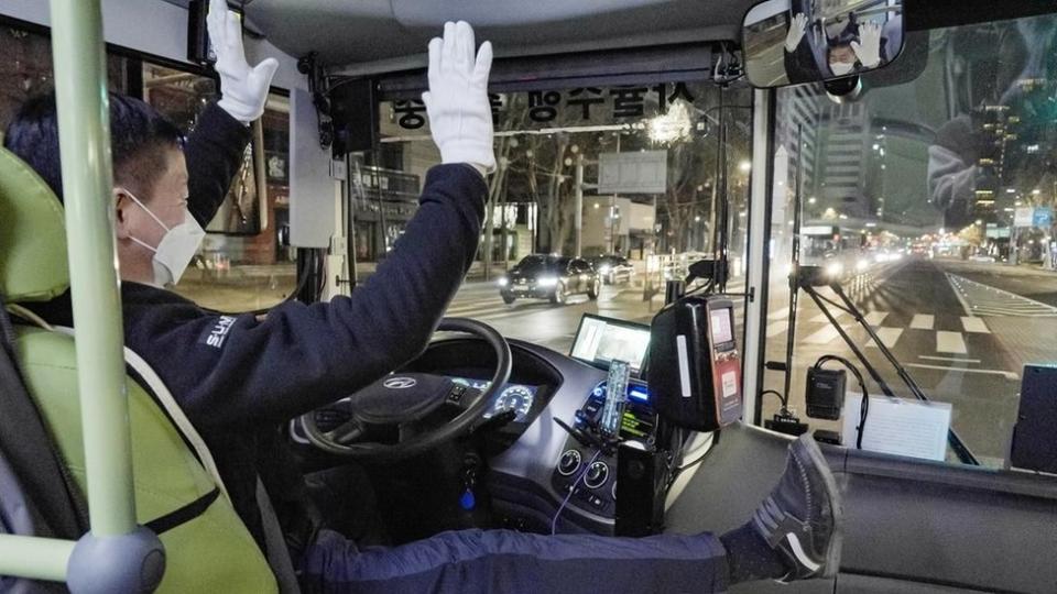 The driver of the A21 bus demonstrates its hands-free features.