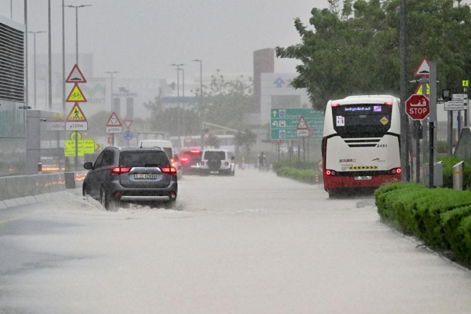 Vehicles drive on a flooded road during torrential rain in the Gulf Emirate of Dubai on April 16, 2024.