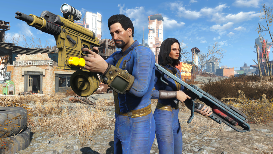 Promotional screenshot for the next-gen console update for Fallout 4. Two (blue-suit-wearing) people stand armed with guns in a video game wasteland. Crumbling buildings and a desert landscape in the background.