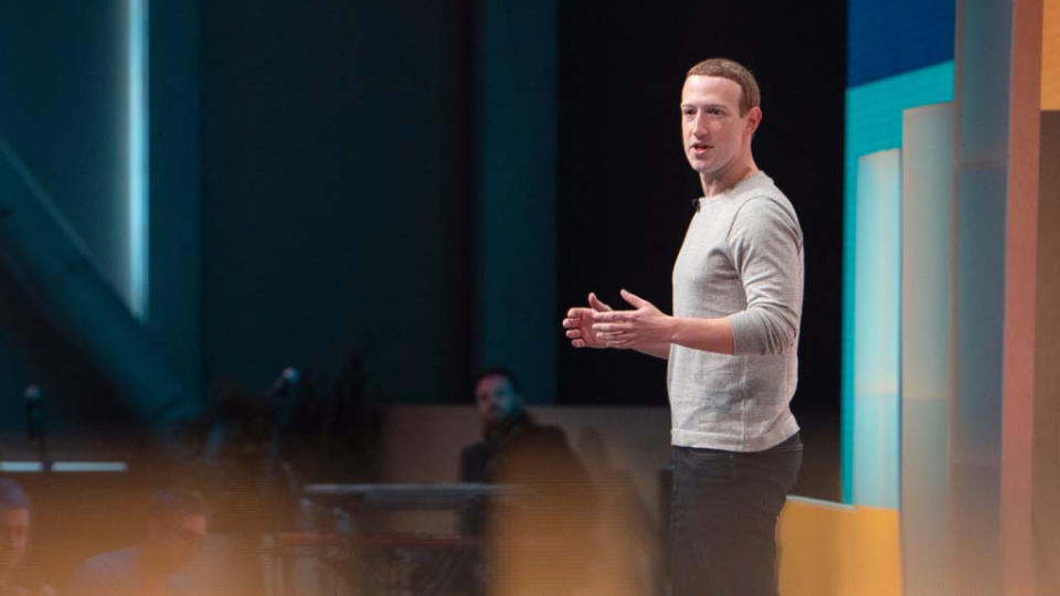 Mark Zuckerberg onstage during a company keynote presentation. Profile view from his left side.