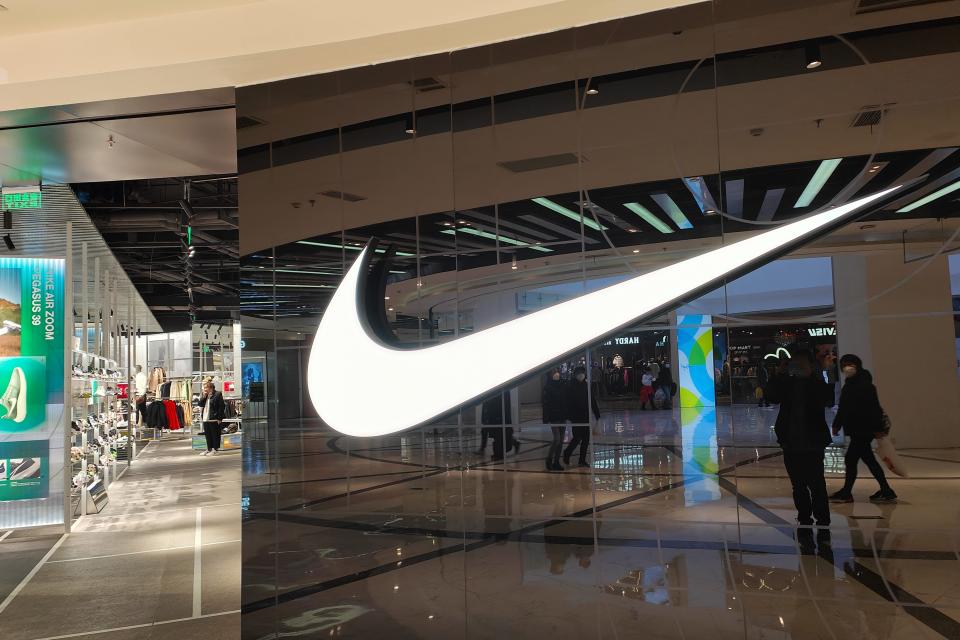 Nike Customers walk past a Nike store in Shanghai, China